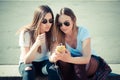 Two beautiful young women using smart phone Royalty Free Stock Photo