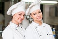 A two beautifull young female chef posing for camera Royalty Free Stock Photo