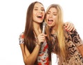 Two beauty girls with a microphone singing and having fun Royalty Free Stock Photo