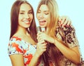 Two beauty girls with a microphone singing and having fun Royalty Free Stock Photo