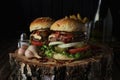 Two beef burgers on a dark background.