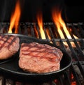 Two Beef Steaks On The Hot BBQ Flaming Grill Royalty Free Stock Photo