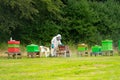 beekeepers at work on api apis in the middle of an open area