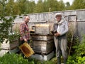 Two beekeepers work about a beehive Royalty Free Stock Photo