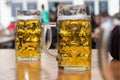 Two beer glasses in german biergarten background Royalty Free Stock Photo