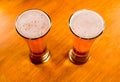 Two beer glasses on wooden table Royalty Free Stock Photo