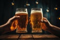 Two beer mugs in hands clink in a pub over a wooden table Royalty Free Stock Photo