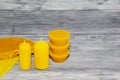 Two beeswax candles on a wooden background.