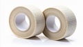 Two Beige Athletic Tapes Rolls on White Reflective Surface in Studio Lighting Royalty Free Stock Photo