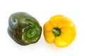 Two bell peppers, green and yellow, laying on a flat surface, isolated on white background with a clipping path