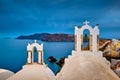 Two bell towers of church in Oia, Santorini island, Greece, seascape. Royalty Free Stock Photo