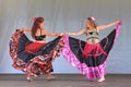 Two belly dancers in long colorful skirts Royalty Free Stock Photo