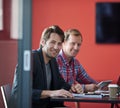 Two of the best in the business. Portrait of two coworkers colleagues sitting at a table in a boardroom. Royalty Free Stock Photo