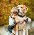 Two best freinds portrait - little boy hugs beagle dog Royalty Free Stock Photo