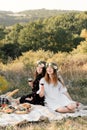 Two best friends on picnic in the field laying on the laid smiling