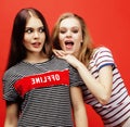 Two best friends teenage girls together having fun, posing emotional on red background, besties happy smiling, lifestyle Royalty Free Stock Photo
