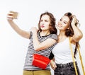 Two best friends teenage girls together having fun, posing emotional on white background, besties happy smiling Royalty Free Stock Photo