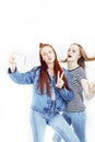 Two best friends teenage girls together having fun, posing emotional on white background, besties happy smiling, making Royalty Free Stock Photo