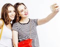 two best friends teenage girls together having fun, posing emotional on white background, besties happy smiling, making Royalty Free Stock Photo