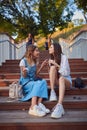 Two best girlfriends chatting in a summer park Royalty Free Stock Photo