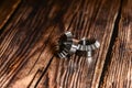 Two bevel gears after manufacturing lie on a wooden background