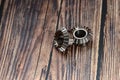 Two bevel gears after manufacturing lie on a wooden background