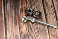 Two bevel gears and vernier caliper on a wooden background