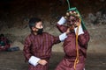 Two boys play with terrifying mask of mask dance , Bumthang, central Bhutan. Royalty Free Stock Photo