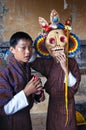 Two Bhutanese boys play with skeleton mask which for the lama dance . Bumthang, central Bhutan. Royalty Free Stock Photo