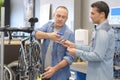 two bicycle repairer colleagues working in bike garage