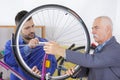 two bicycle repairer colleagues working in bike garage