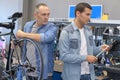 two bicycle repairer colleagues working in bike garage