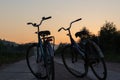 two bicycles on the background of a beautiful sunset sky Royalty Free Stock Photo