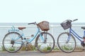 Two bicycles chained to the fence of promenade in Southwold, UK