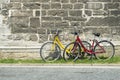 Two bicycles, one red and one yellow