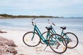 Two bicycles parked on sandy beach on Rottnest Island, Western Australia. Royalty Free Stock Photo