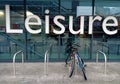 Bicycles parked in front of a glass fronted modern Leisure center building in Romford Royalty Free Stock Photo