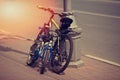 Two bicycles stand parked to a streetlight