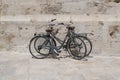 Two bicycles standing next to an ancient stone wall Royalty Free Stock Photo
