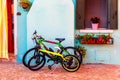 Two bicycles by the wall of the authentic house in Burano, Italy. Royalty Free Stock Photo