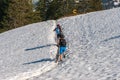 Two bicyclist in mountains covered with snow in spring with a bike in arms