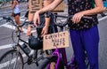 Two bicyclists at a Black Lives Matter protest with signs