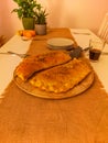 Two big calzone pizzas on wooden plate on big table Royalty Free Stock Photo