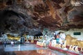 Two big figures of a reclining Buddha. Temple in a cave, ancient figurines carved on the rocky walls. Hpa An, Myanmar, Burma,