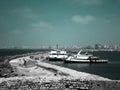 Two Big Fish boats parking next to the walls of the Citadel of Qaitbay on the coast of Alexanderia, Egypt