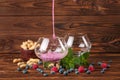 Two big glasses with fruit juice, bilberries, raspberries, peanuts in a bowl, mint on a dark brown wooden background. Royalty Free Stock Photo