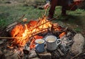 Two big mugs with hot tea and lemon near the campfire place