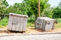 Two big old metal dumpster garbage cans on the street damaged by vandals Royalty Free Stock Photo