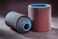 Two big rolls of sand paper on abrasive background Royalty Free Stock Photo