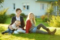 Two big sisters and their little brother having fun outdoors. Two young girls holding toddler boy on autumn day. Children with Royalty Free Stock Photo